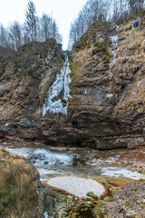 Winter. Ice games in the Fontanon of Goriuda waterfall. Friuli, Italy.
