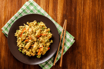 Fried rice nasi goreng with chicken and vegetables on a plate - 315013661