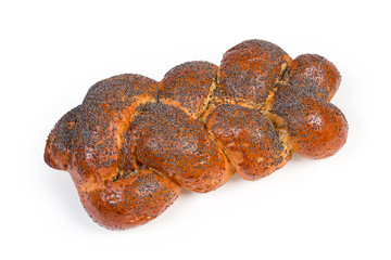Sweet braided bread sprinkled with poppy seeds on white background