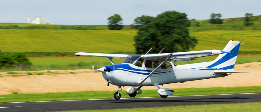 Light aircraft landing on aerodrome runway