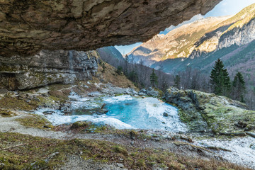 Fototapeta na wymiar Winter. Ice games in the Fontanon of Goriuda waterfall. Friuli, Italy.