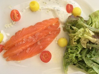 salmon with lemon and parsley on white plate
