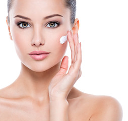 Fototapeta premium Beauty face of woman with cosmetic cream on face