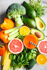 Orange detox smoothie in glass. Ingredients for detox smoothie background, top view. Healthy food concept.