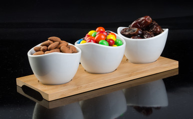 almond with chocolate and dates on a background new.