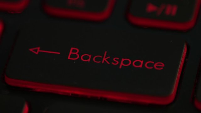 clicking finger pressing backspace button on keyboard computer 