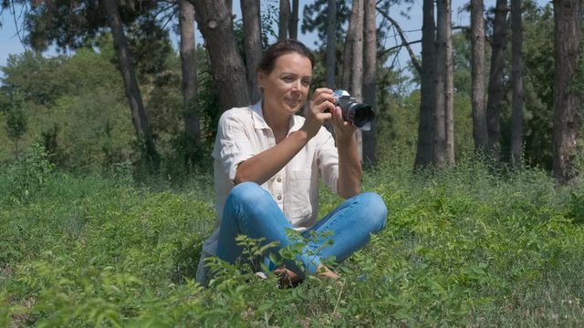 Female take photo on professional camera.