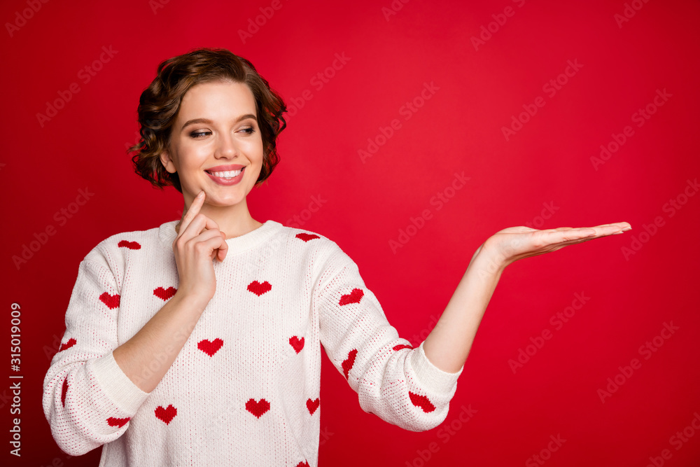 Sticker Close-up portrait of her she nice attractive lovely content cheerful cheery girl holding on palm invisible product ad advert isolated over bright vivid shine vibrant red color background