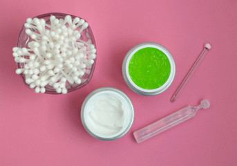 face cream, serum, aloe gel mask, on a pink background, close-up