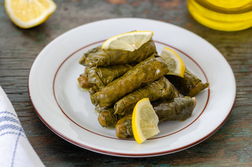 Stuffed grape leaves with rice,olive oil and herbs in white plate