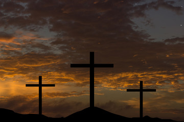 silhouette of three crosses on a hill at sunrise, easter theme