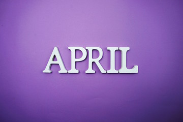 April alphabet letters on purple background