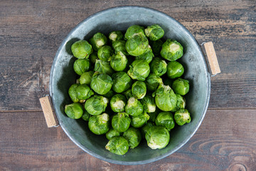 fresh raw brussels sprouts on wooden table