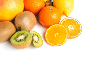 Group of tropical fruits, sliced halves of orange and kiwi isolated on white background