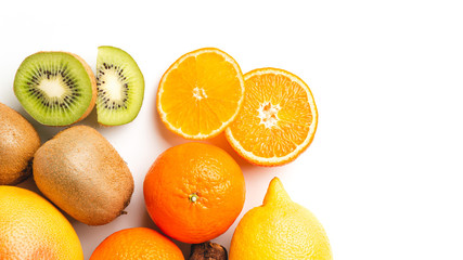 Assortment of tropical fruits, group of orange, kiwi, tangerine, lemon isolated on white background, top view