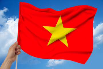 photo of the national flag of Vietnam on a luxurious texture of satin, silk with waves, folds and highlights, close-up, copy space, concept of state economy and politics