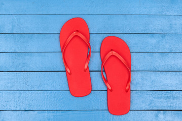 flip flops on wooden blue table