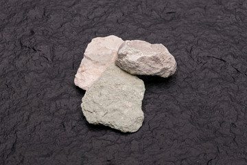 Zeolite natural raw stones on black background. Macro shot
