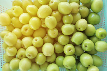 Fresh of Jujube or Monkey apple fruit put on the green basket with soft light