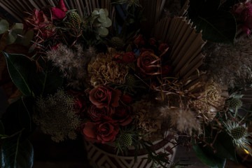 Detail view of a flower arrangement. Still life with roses in a ceramic vase.