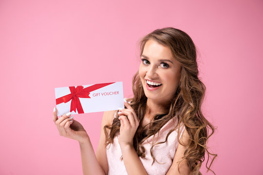 Portrait Of Beautiful Woman Holding A Gift Voucher