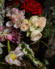 composition of red, pink and white roses on a blurred background.