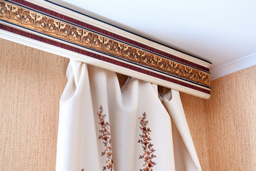 Curtains made of natural fabric and cornice close-up © lial88
