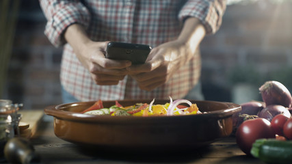 Woman taking a picture of her healthy recipe