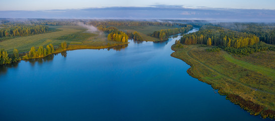 Fototapeta na wymiar Sunset aerial atmospheric view on river in Ural Russia. Drone photography