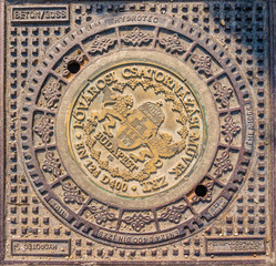 Fototapeta na wymiar Old sewer manhole on a street in Budapest, Hungary 