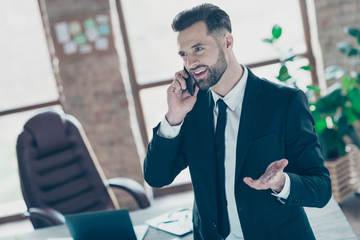 Photo of successful handsome business guy holding telephone speaking partners friendly mood wear...