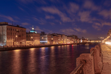 Beautiful dawn in St. Petersburg over the river. Reflection in the water of lanterns.