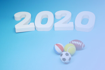 White Wooden 2020 with Football Tennis ball Volleyball Rugby on blue  background - 2020 sport and activity concept - New Challenge and New Goal for the Winner 