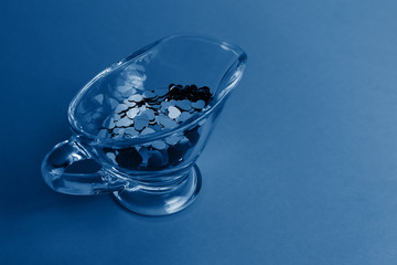 A lot of hearts in a transparent glass dish. Toned trendy classic blue color of year 2020. Copy space: Valentines and 8 March Mother Women's Day concept