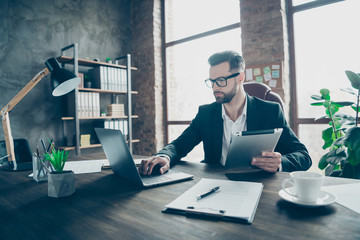 Photo of handsome business chief guy holding e-reader checking notebook report comparing partners...