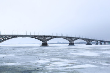 Bridge across the Volga river between the cities of Saratov and Engels. Ice on the river. Russia