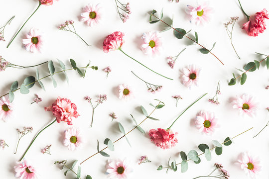 Flowers composition. Pattern made of pink flowers and eucalyptus branches on white background. Valentines day, mothers day, womens day concept. Flat lay, top view