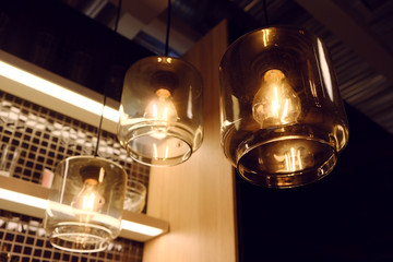 Three yellow lamp of modern style in modern cafe or bar interior.