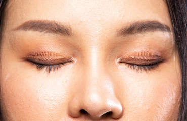 Obraz premium Collage Group Portrait of Fashion Young beautiful Asian Woman black hair attaches artificial eyelid to create double tapes for eyes makeup. Girl shows eyeslid with color brush on face, dark background