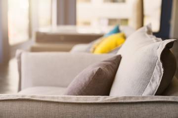 close up of soft fabric pillow decoration on beautiful sofa in living room home design concept