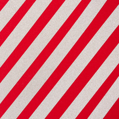 Silver glitter diagonal stripes on red background. Holiday pattern