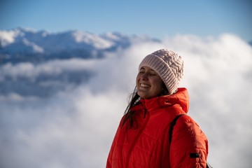 Girl smiling in the middle of the snowy mountains