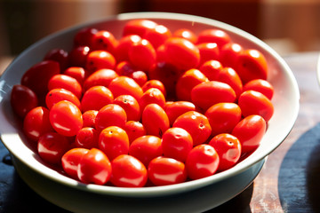 Cherry tomato in bowl, with sunshine 