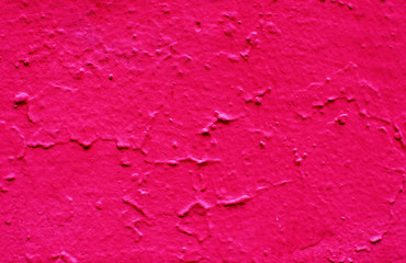 Rough uneven red paint on the plaster.