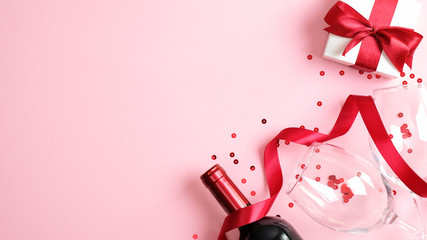 Valentine's day dinner, table setting for romantic dinner with bottle of wine champagne, two...