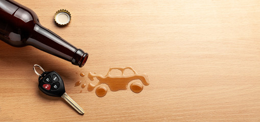 Fototapeta na wymiar Drunk driving. Accident with a broken car from alcohol. Beer bottle and car keys. Broken car