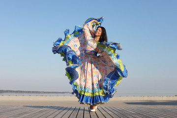 young woman dancing in gypsy dress