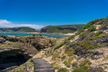 Winding wooden path to the beach. Outdoor coastal background