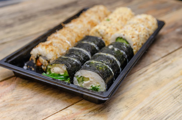 Set sushi Toto Maki, Bonito Maki, Akito Maki on a wooden background. Top view, side view