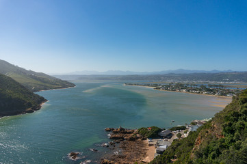 Fototapeta premium Aerial view of Knysna lagoon with forest covered mountains